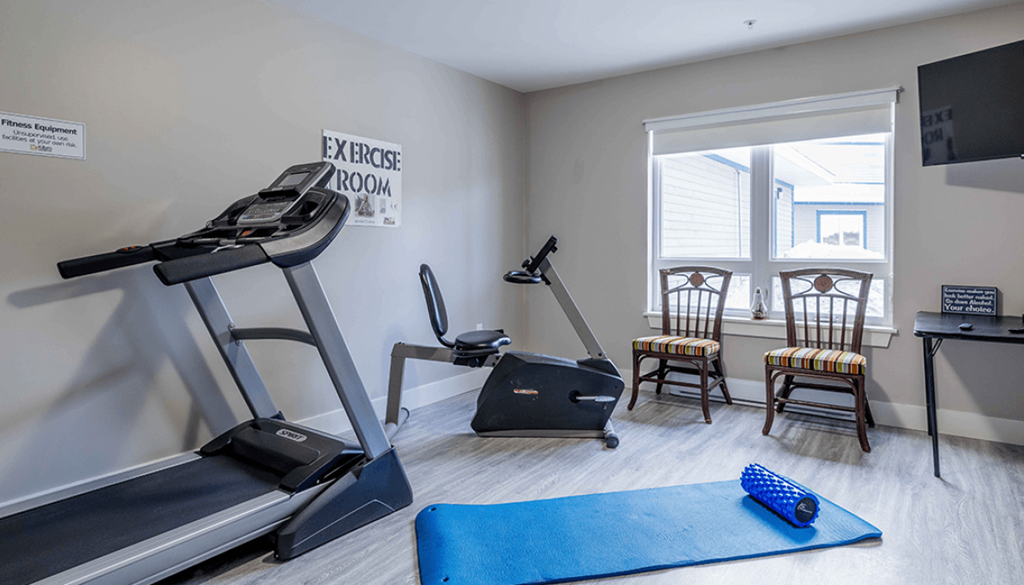 A room with exercise equipment and a treadmill.