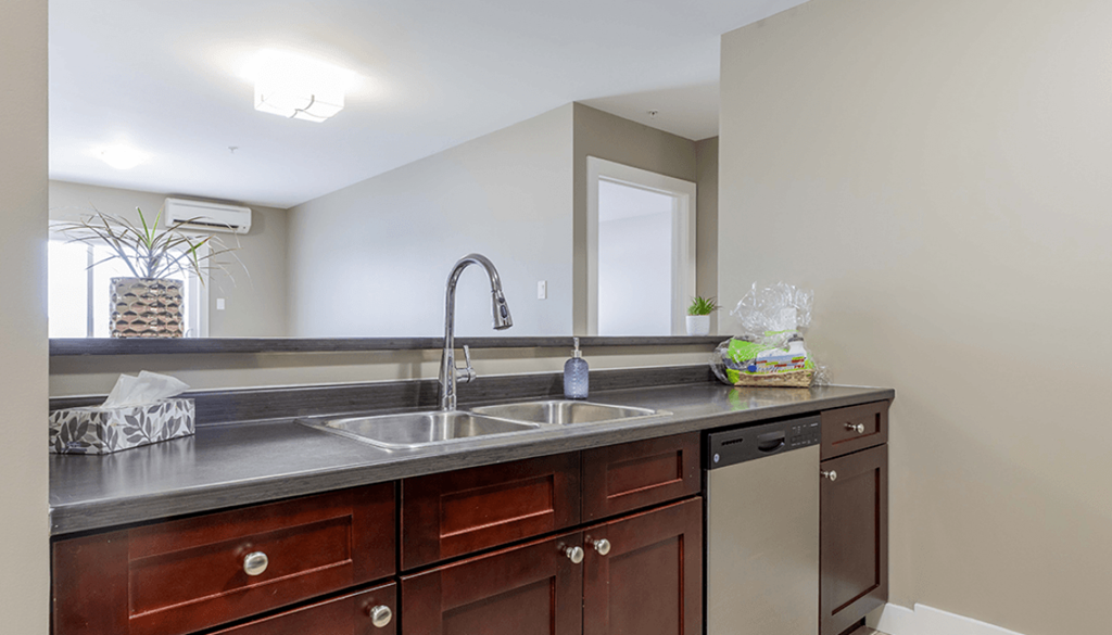 A kitchen with a sink and a counter.