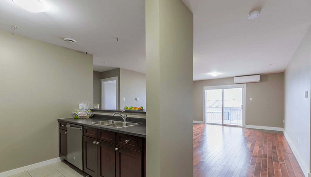 A kitchen with brown cabinets and a white sink.