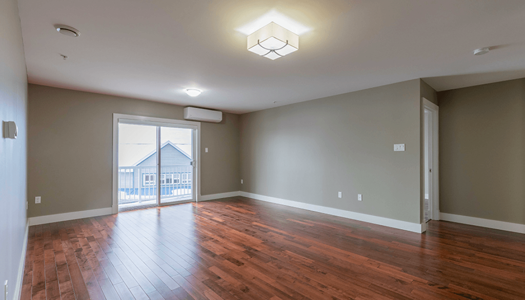 A room with wooden floors and a ceiling light.