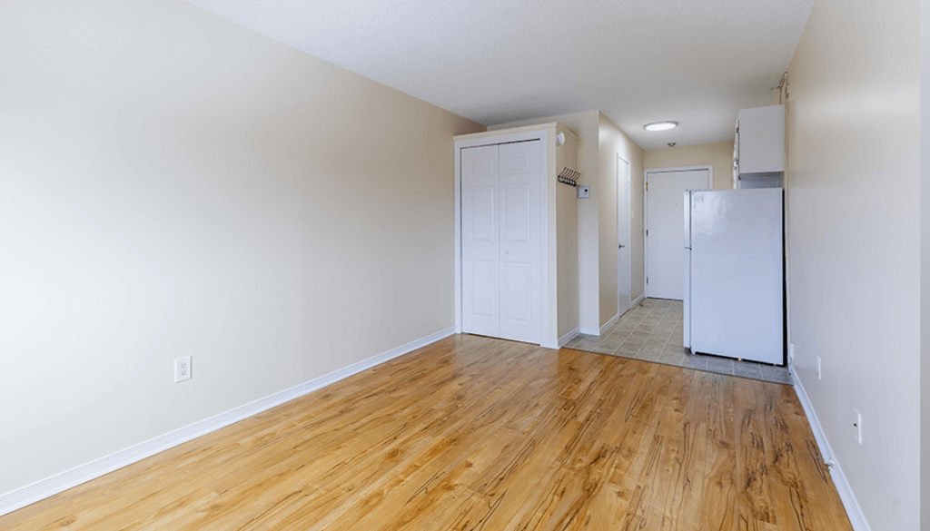 A room with wooden floors and white walls.