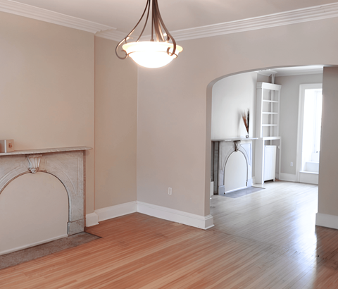 A room with a fireplace and a chandelier.