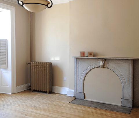 A room with a fireplace and a radiator.