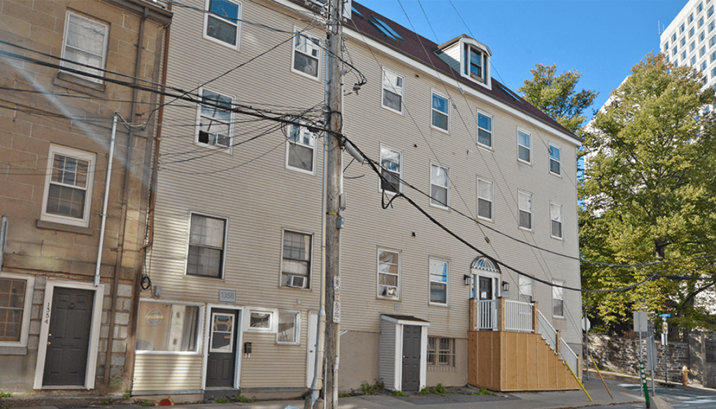 a large apartment building on the corner of a street