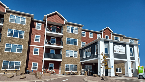 The image shows a multi-story building with a sign that reads "The Place at Beaulieu."