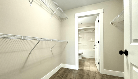 A white door is open to a bathroom.