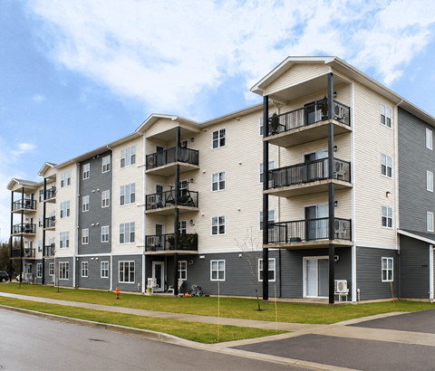 Apartment building with balconies and doors.