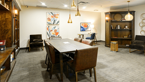 a conference room with a long wooden table and chairs