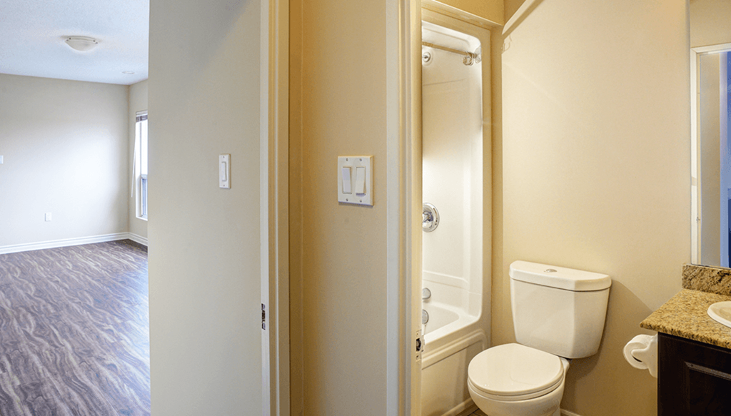 a bathroom with a toilet and a shower