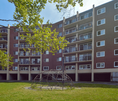 A large building with a tree in front of it.