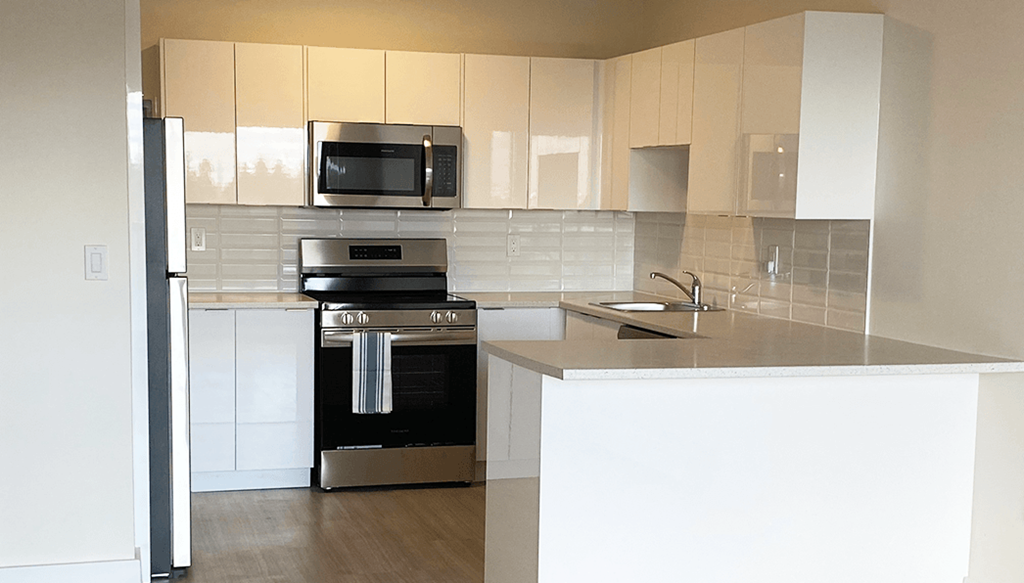 A modern kitchen with a black oven and microwave.