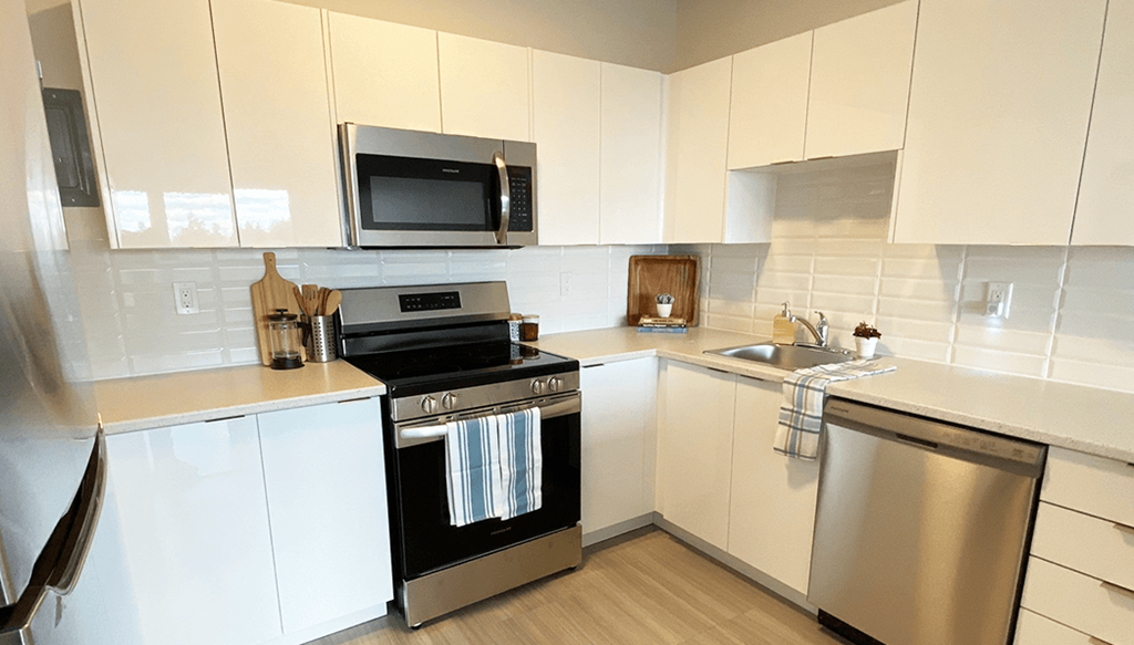 A modern kitchen with a stove, oven, and microwave.