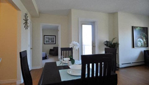 a dining room with a table and chairs