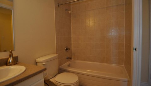 a bathroom with a toilet and a tub and a sink