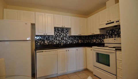 a kitchen with white appliances and white cabinets