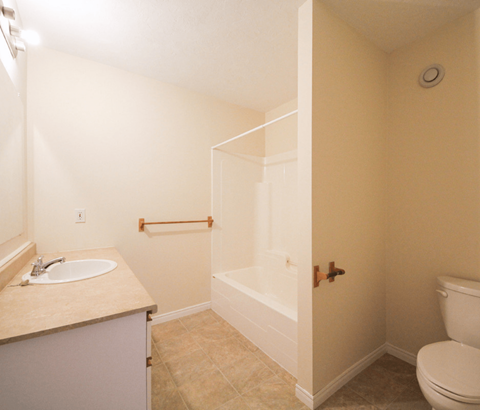 A bathroom with a toilet, sink, and bathtub.