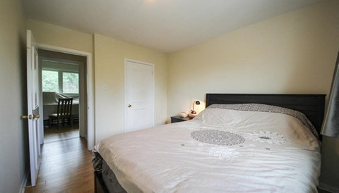 a bedroom with a bed and a door to a bathroom