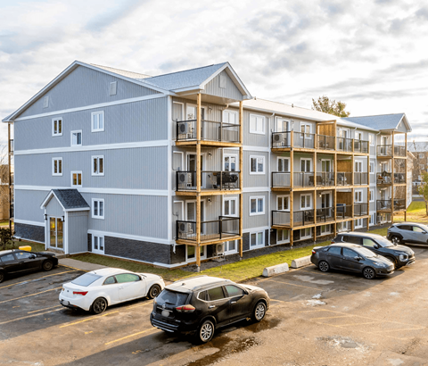 A large building with a parking lot in front of it.