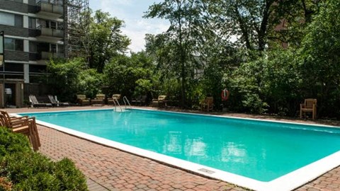 a swimming pool in front of an apartment building