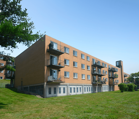 A large apartment building with balconies and doors.