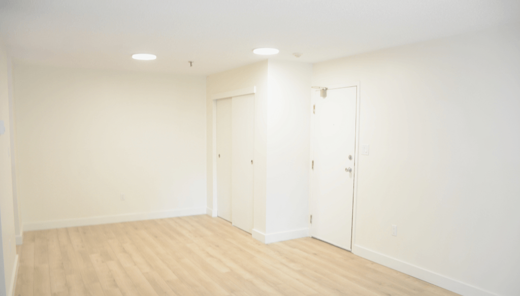 A room with wooden floors and white walls.