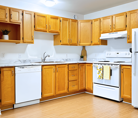 A kitchen with wooden cabinets and white appliances.