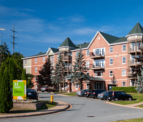 A large brick building with a green roof and a sign that says 31 on the front.