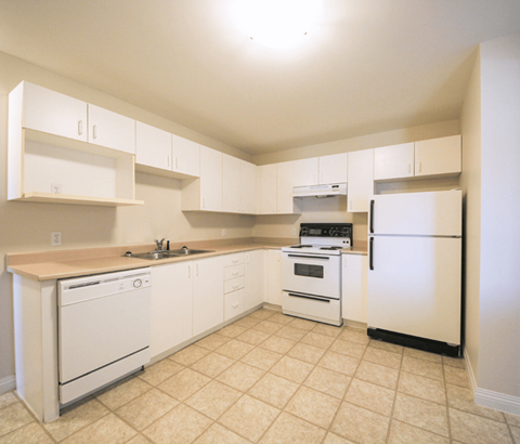 A kitchen with white appliances and cabinets.