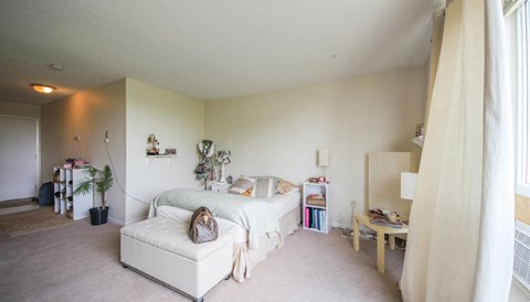 a bedroom with a bed and a white couch