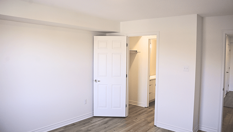 A white door is open to a hallway.