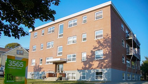 A multi-story apartment building with a sign that reads 3565 Commerce Avenue.