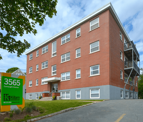 A red brick building with a yellow sign in front that says 3565 Cornwall Avenue.