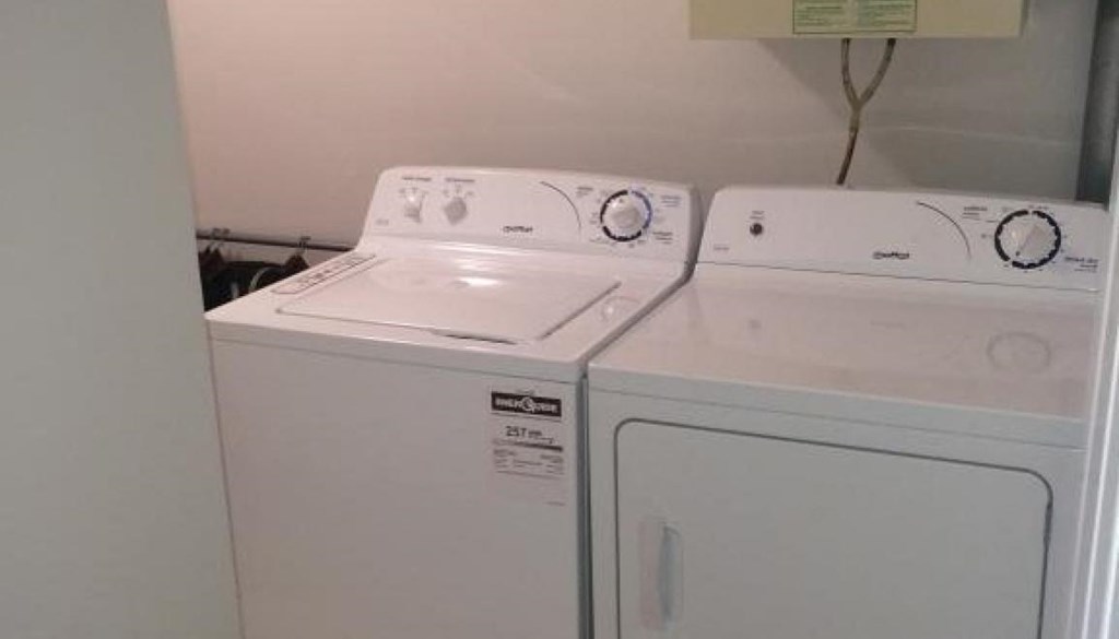 two washing machines sitting next to each other in a room