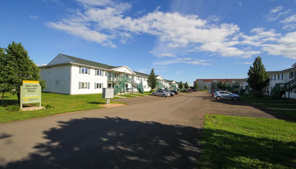 a street with houses and cars parked in front of them