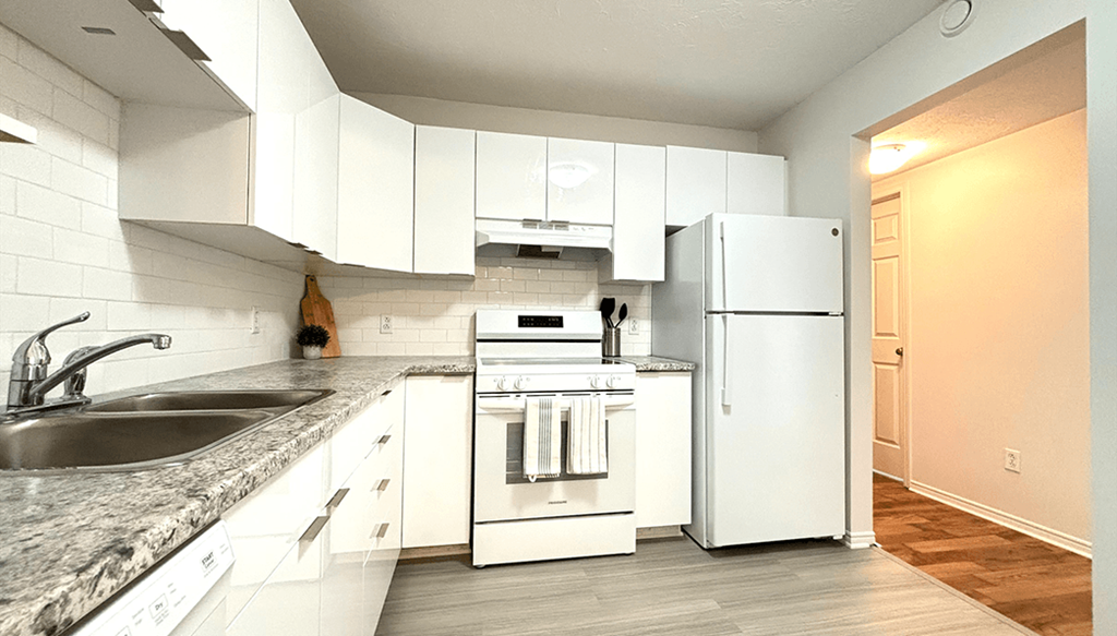 a kitchen with white appliances and white cabinets