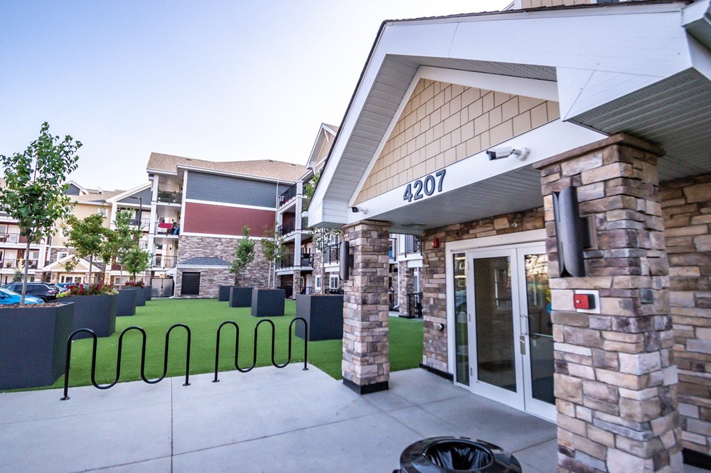 the side of a building with a green lawn in front of it