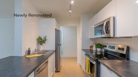 a kitchen with stainless steel appliances and black counter tops