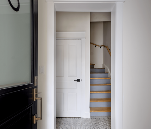 A white door is open to a staircase.