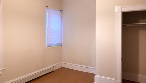 A room with a window and a door.