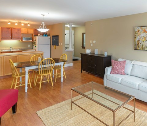 A kitchen with a dining table and chairs.