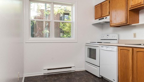 a kitchen with white appliances and a window