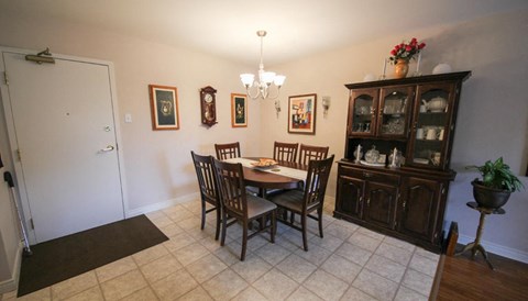 A dining room with a table set for four.