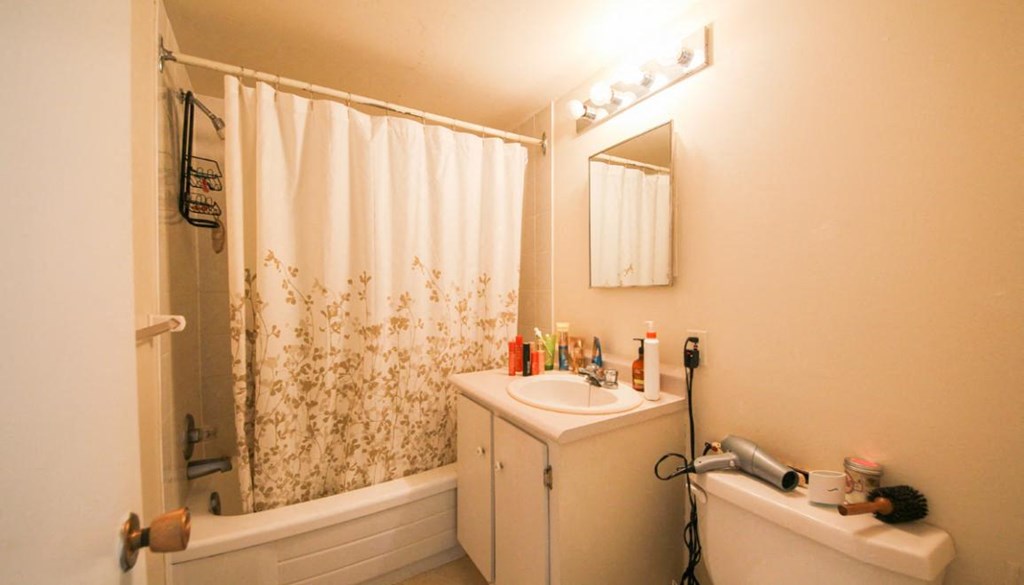 a bathroom with a sink and a shower and a toilet