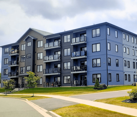 A large apartment building with balconies and multiple windows.