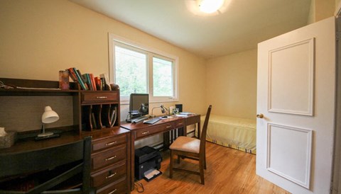 a home office with a desk and a window