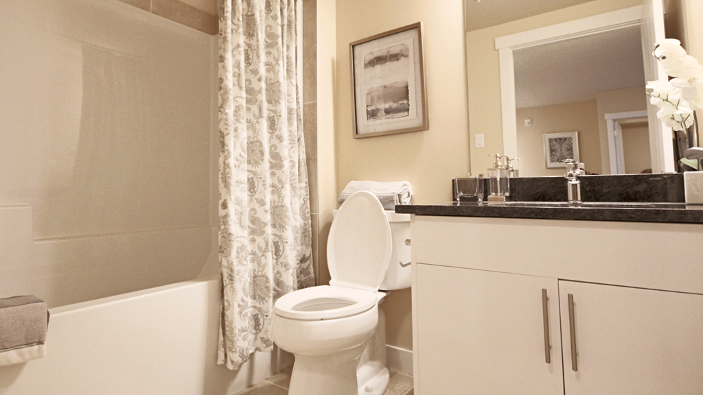 a bathroom with a toilet and a tub and a sink