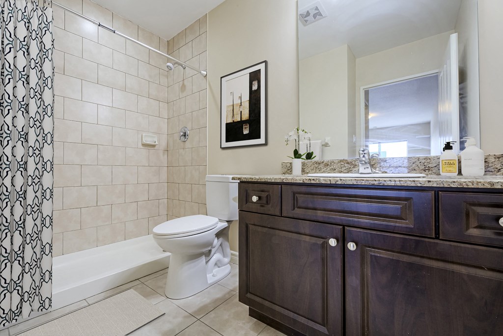 a bathroom with a toilet and a sink and a shower