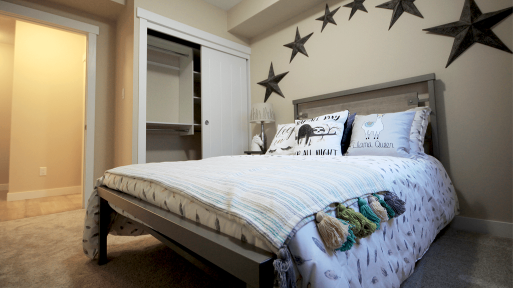 a bedroom with a bed and stars on the wall