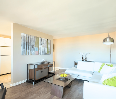 A modern living room with a white couch and a coffee table.