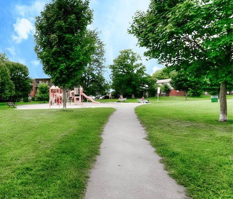 A playground with a slide is in the middle of a grassy area.